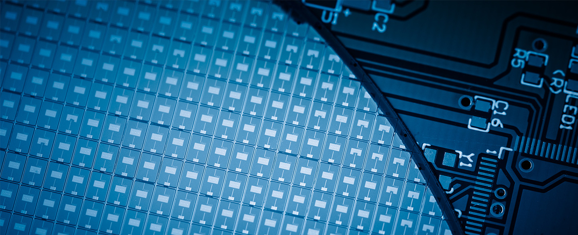 Semiconductor wafer patterned with a grid of microchips overlapped by a printed circuit board; PCB traces and component pads surround the wafer in a cool blue light.

Text visible on PCB: U1, C2, R5, LED1, Y1